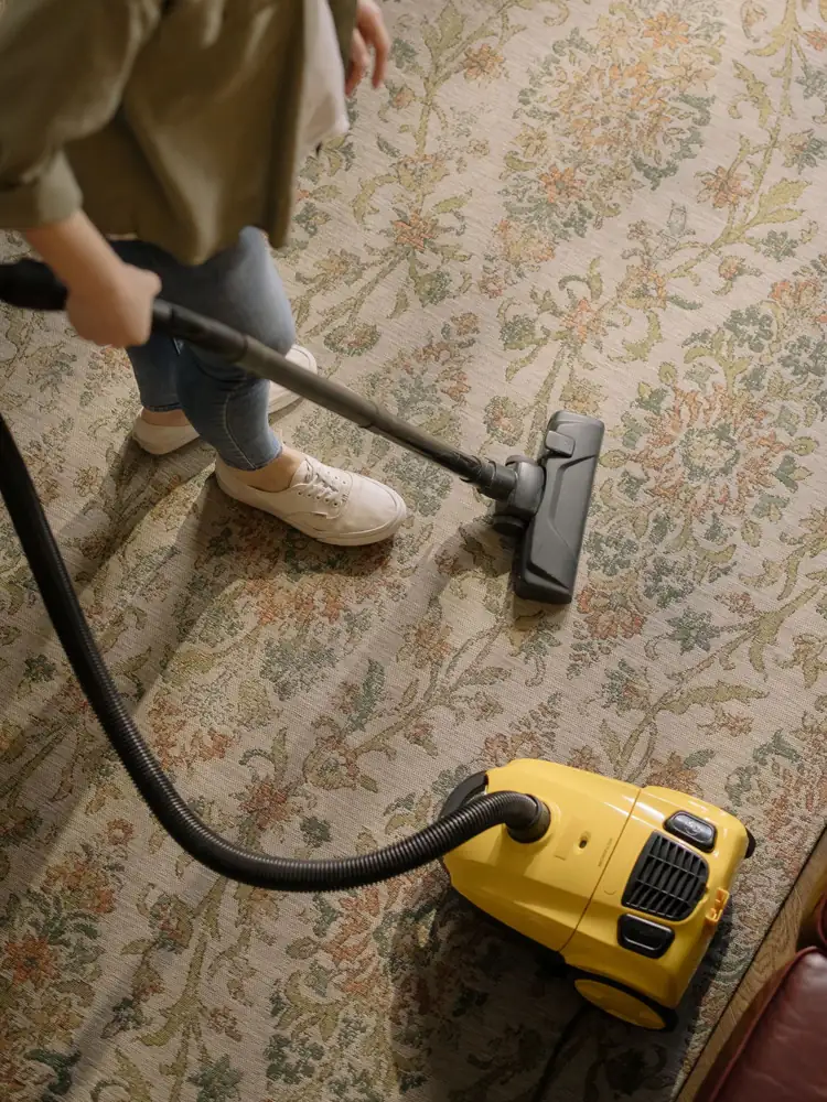 Carpet being cleaned with a vacuum cleaner